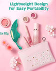 Teal rose wearable vibrator beside a pink cosmetics pouch and makeup items in a portability graphic labeled 38 grams