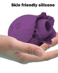 Purple rose suction unit resting in a hand, showing flower opening and two onboard control buttons