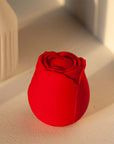 Red rose tapping stimulator with layered petals, a broad rounded central pad and one front power button