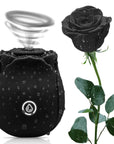 Black rose-shaped suction and vibration toy beside a black rose