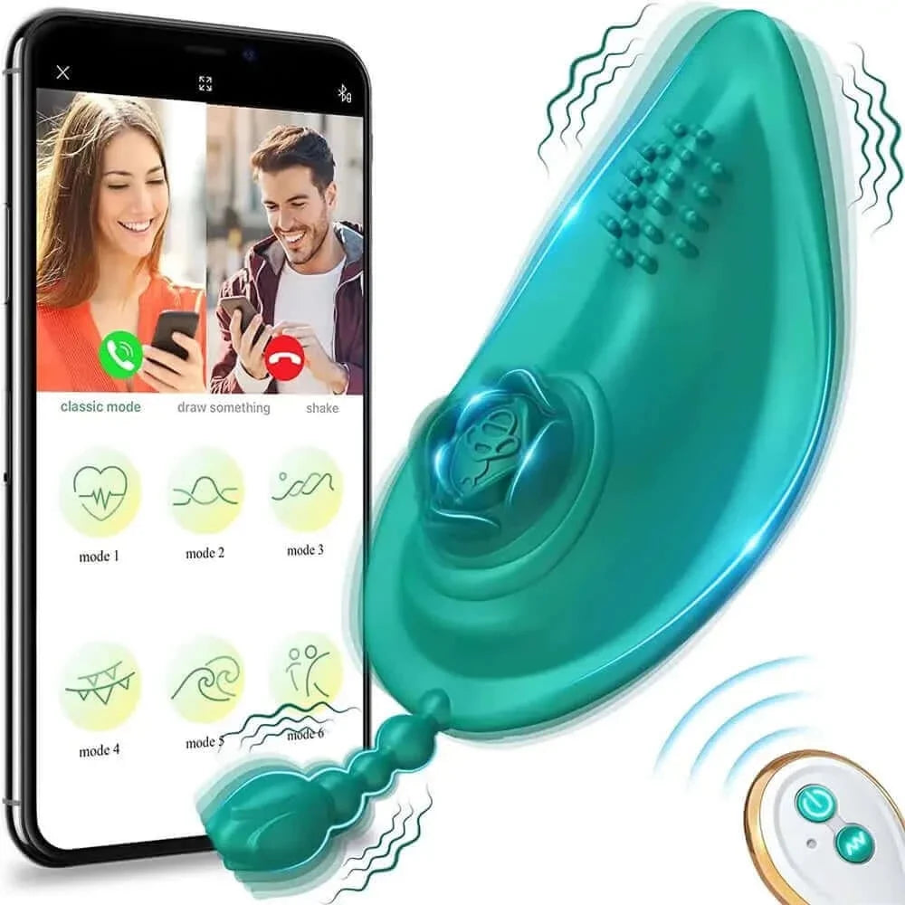 Teal wearable vibrator with a raised rose detail, dotted surface and short beaded tail, pictured beside a phone interface and two-button white remote