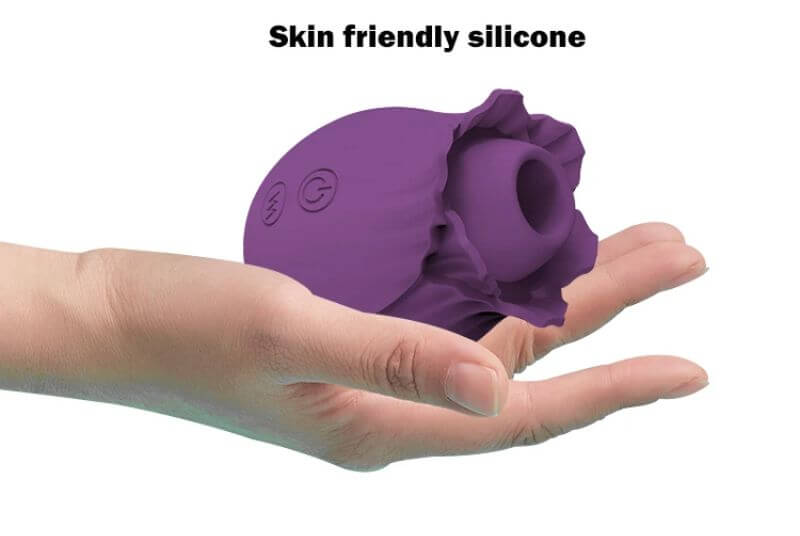 Purple rose suction unit resting in a hand, showing flower opening and two onboard control buttons