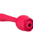 Angled view of the red Dora rose vibrator showing the central air-pulse opening framed by petals and its curved opposite stem