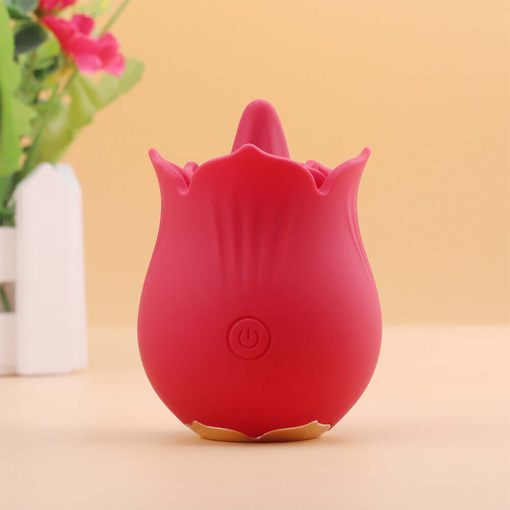 Red Doreen rose tongue vibrator standing upright with a projecting tongue, layered petal rim, single front power button and gold-colored base trim
