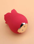 Underside of the red Doreen rose tongue vibrator showing two magnetic charging contacts within a gold-colored scalloped base plate
