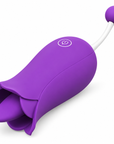 Purple flower tongue vibrator with open petals, a single body button and a rounded bead on the opposite white stem