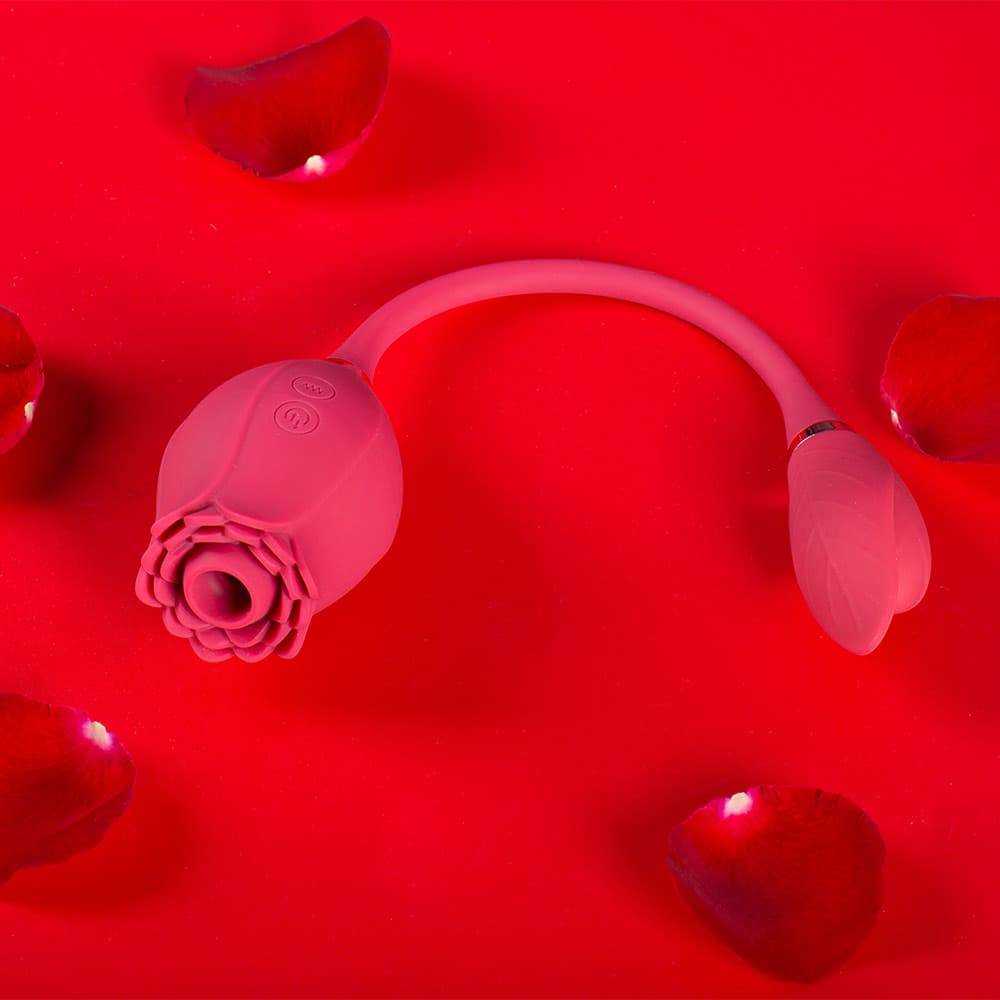 Pink Mermaid rose suction vibrator with two side buttons, central flower opening and a flexible cord leading to a petal-shaped vibrating egg