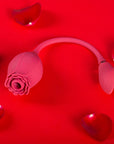 Pink Mermaid rose suction vibrator with two side buttons, central flower opening and a flexible cord leading to a petal-shaped vibrating egg