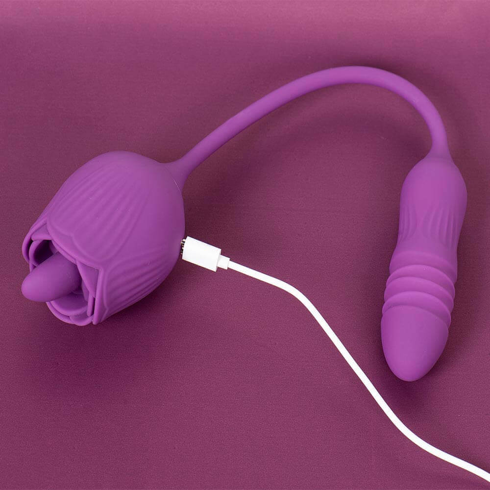 Purple Rhea rose tongue vibrator with a flexible connecting cord, rounded ribbed opposite end and white magnetic cable attached to the rose body