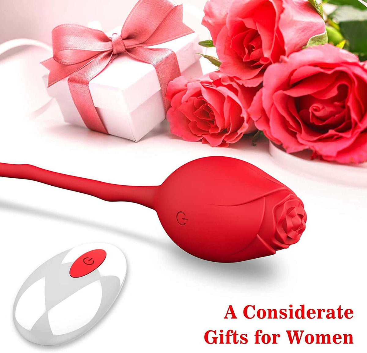 Red rose vibrating egg and white wireless remote arranged beside red roses and a decorative white gift box with a pink ribbon
