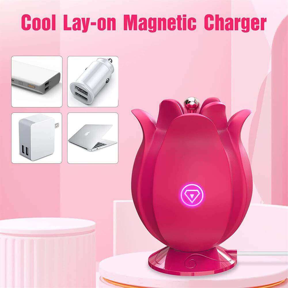 Rose pinpoint vibrator standing on a matching pink magnetic charging base with a cable exiting to the side