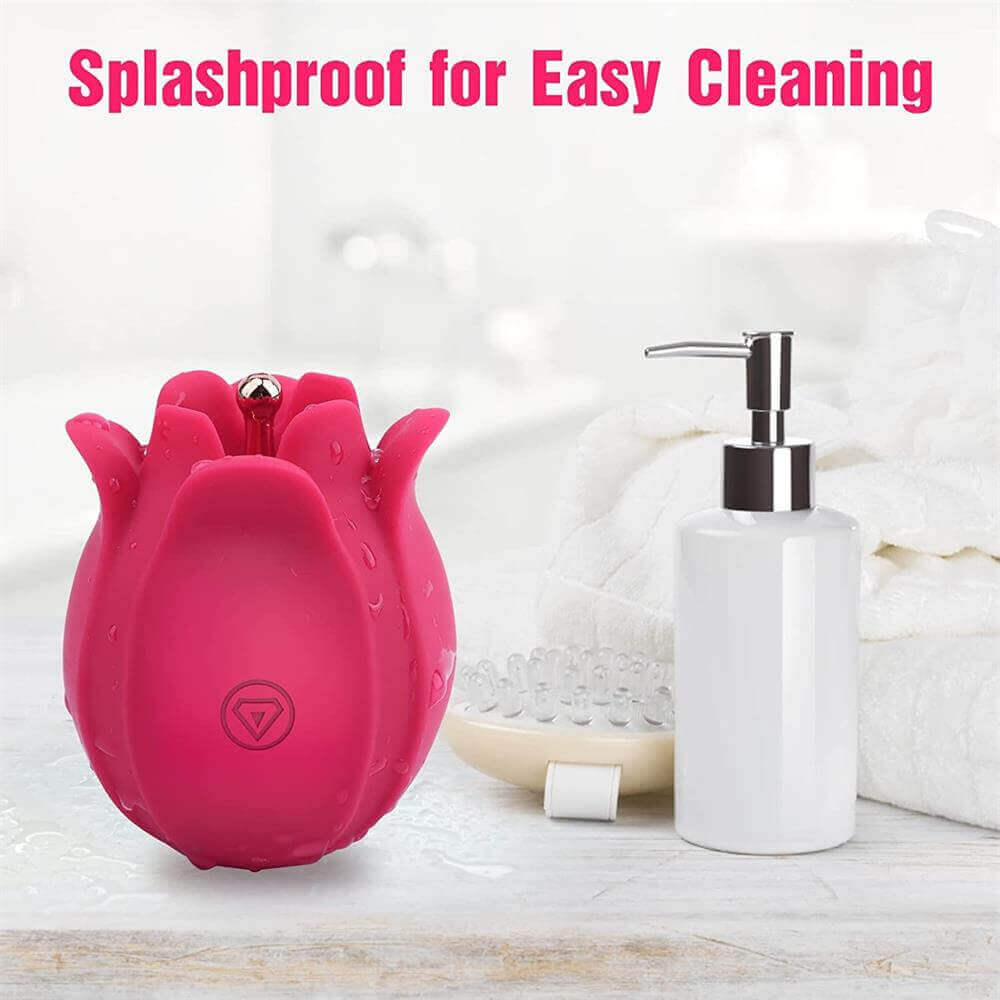 Rose pinpoint vibrator pictured beside cleaning supplies with a splashproof label and droplets on the petals