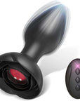 Black rose remote control vibrating plug with tapered bud, broad flower base and red underside panel beside a matching black three-button remote