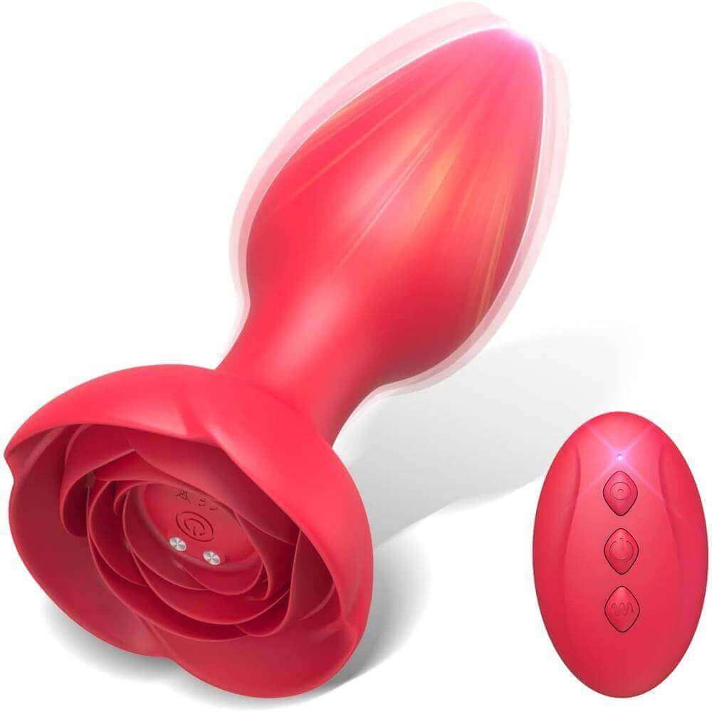 Red rose remote control vibrating plug with a tapered bud, wide petal base, underside power button and charging contacts beside a three-button remote