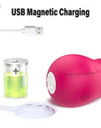 White round magnetic charging dock beside a pink rose-shaped device with two underside contacts; device shown for illustration