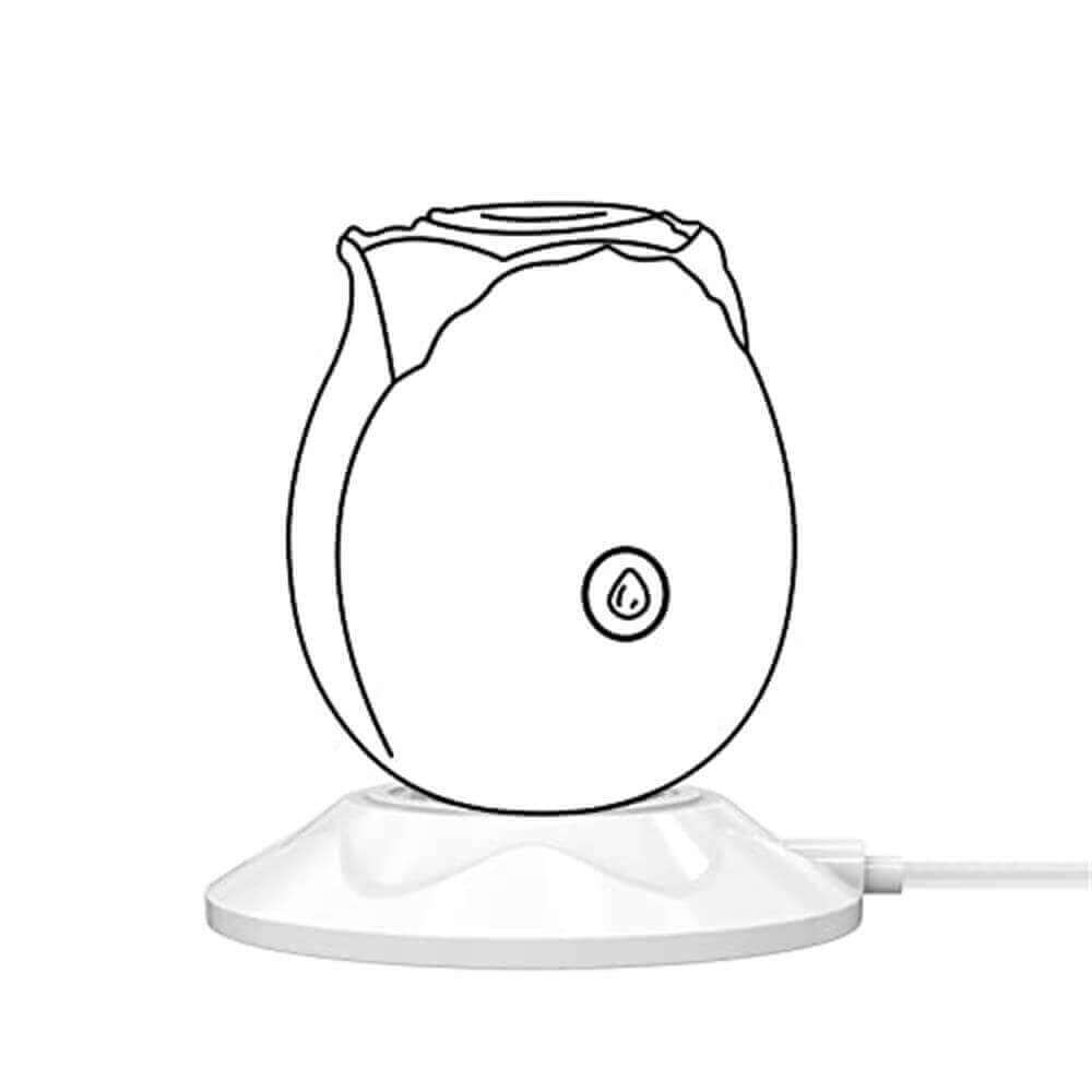 Outline of a rose-shaped device resting on the white round charging dock, with the cable exiting to the side