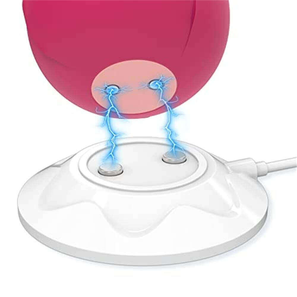 Illustrated alignment of two contacts on a white round magnetic dock with the underside contacts of a pink rose-shaped device