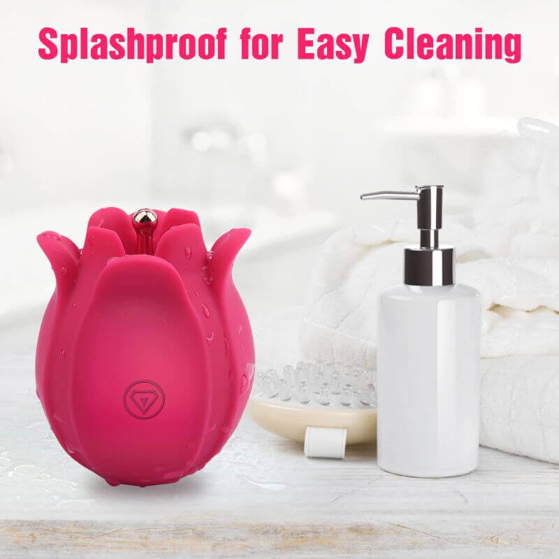 Pink rose massager with water droplets beside a soap dispenser and towel